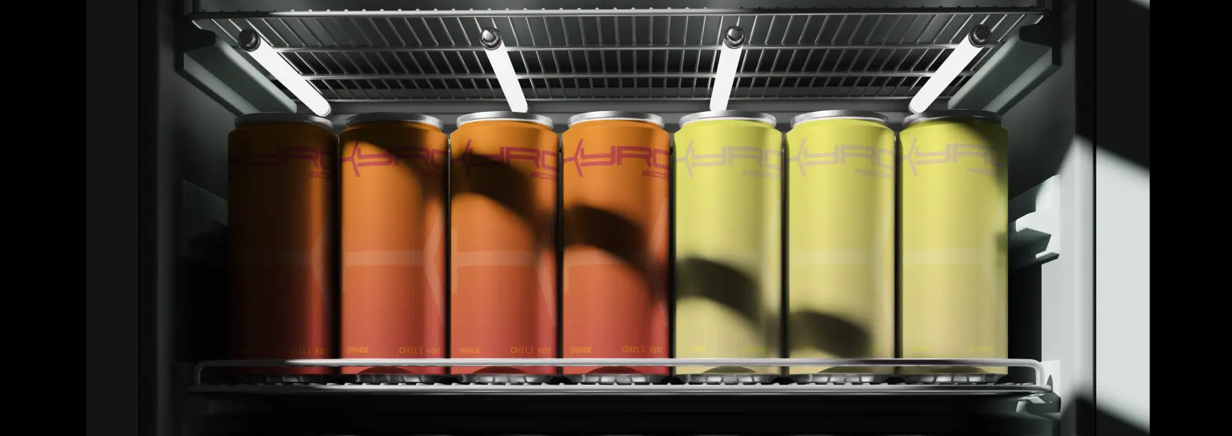 Orange and yellow KYRO cans lined up on a lit refrigerator shelf