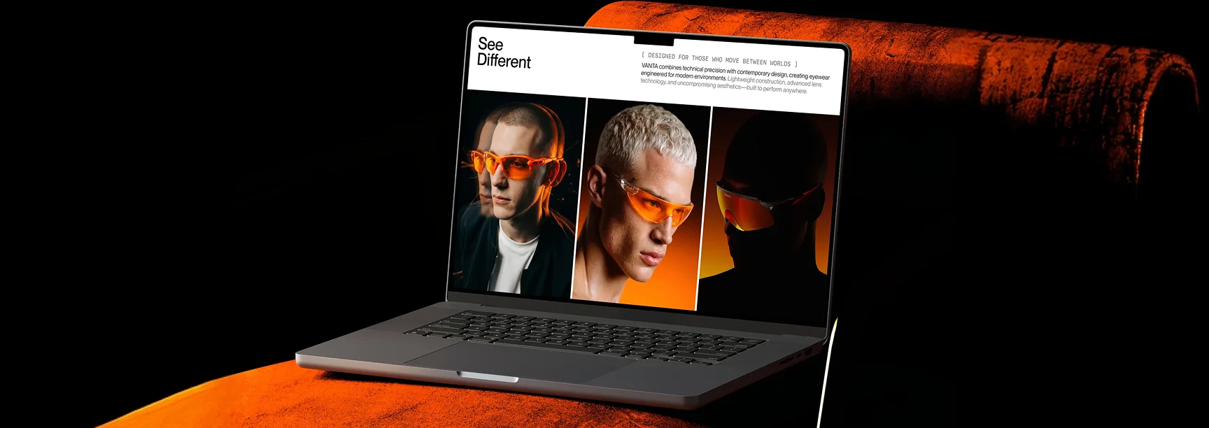 Laptop showing the VANTA homepage with the See Different headline and three models in orange-tinted eyewear