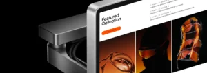 A sleek metal display stand showing a website with the headline Featured Collection and product images of Vanta eyewear.